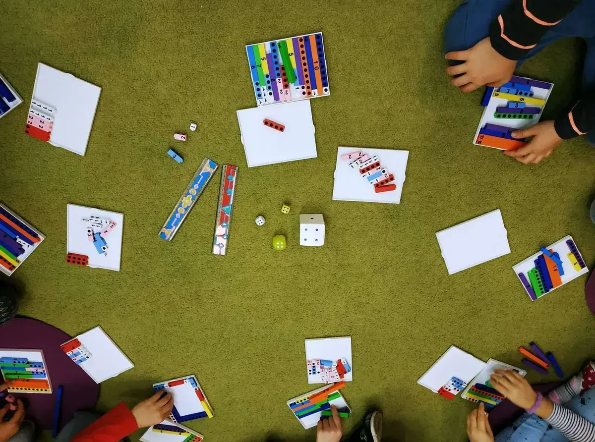 Dzieci podczas zajęć edukacyjnych przy stolikach